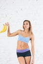 Happy young fitness woman with bananas Royalty Free Stock Photo