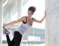 Happy young fitness woman stretching outdoors Royalty Free Stock Photo