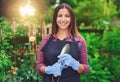 Happy young florist at work in her nursery