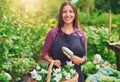Happy young florist working in a greenhouse Royalty Free Stock Photo
