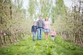 Happy young four member family standing together outdoors in orc