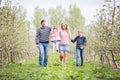 Happy young four member family walking together outdoors in orc Royalty Free Stock Photo