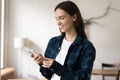 Happy young freelance business woman in casual typing on smartphone Royalty Free Stock Photo