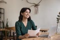 Happy young freelance business woman holding legal documents