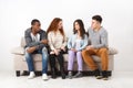 Happy young friends, casual people sitting on couch Royalty Free Stock Photo