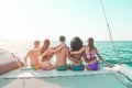 Happy young friends chilling in catamaran boat - Relaxed people making ocean caribbean tour - Travel lifestyle, summer, friendship