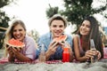 Happy friends having fun on the beach and eating watermelon. Royalty Free Stock Photo