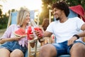 Happy friends having fun on the beach and eating watermelon. Royalty Free Stock Photo