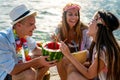 Happy friends having fun with tropical cocktails on beach party. Travel and summer vacation concept. Royalty Free Stock Photo