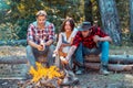 Happy young friends having picnic. Group of friends enjoying picnic in the forest. Happy friends on a camping trip Royalty Free Stock Photo