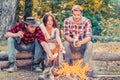 Happy young friends having picnic. Group of friends enjoying picnic in the forest. Happy friends on a camping trip Royalty Free Stock Photo