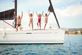 Happy Friends jumping from sailing boat in sea Royalty Free Stock Photo