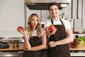 Happy young friends loving couple chefs on the kitchen cooking. Royalty Free Stock Photo
