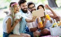 Happy friends in the park having picnic on a sunny day. Royalty Free Stock Photo