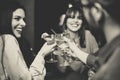 Happy young friends toasting and cheering cocktails at disco bar - Multiracial people having fun enjoying drinks at club