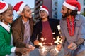 Happy young friends wearing Santa Claus hat celebrating together at Christmas Royalty Free Stock Photo