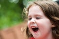 Happy Young Girl on Amusement Ride with Hair Blowing in Wind Royalty Free Stock Photo