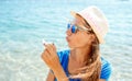 Happy young girl blowing soap bubbles on the seashore Royalty Free Stock Photo