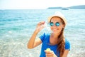 Happy young girl blowing soap bubbles on the seashore Royalty Free Stock Photo