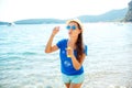 Happy young girl blowing soap bubbles on the seashore Royalty Free Stock Photo