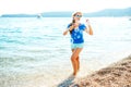 Happy young girl blowing soap bubbles on the seashore Royalty Free Stock Photo