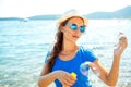 Happy young girl blowing soap bubbles on the seashore Royalty Free Stock Photo