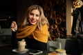 Happy young girl in cafe with glass of coffee. Positive emotions and smile Royalty Free Stock Photo