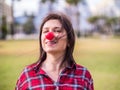 Happy young girl with a clown nose. Joke, humor and funny portrait concept. April fools day Royalty Free Stock Photo