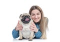 Happy young girl cuddles and hugs pug dog, isolated on white background Royalty Free Stock Photo