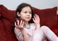 pretty young girl eating an apple on the couch in the livingroom