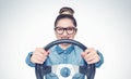 Happy young girl with glasses and car steering wheel, front view, auto concept Royalty Free Stock Photo