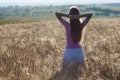 Happy young girl in golden wheat field. Young woman enjoying nat Royalty Free Stock Photo