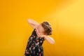 Happy young girl with her hands clasped together beneath her chin, smiling joyfully Royalty Free Stock Photo