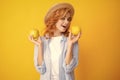 Happy young girl holding apple isolated over yellow background. Portrait of pretty woman with an apple close up. Royalty Free Stock Photo