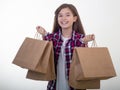 Happy young girl holding discount white card and shopping bags in her hands. Kid with credit card. Royalty Free Stock Photo