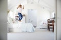 Happy young girl jumping on her bed in her bedroom Royalty Free Stock Photo