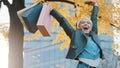 Happy young girl jumping with the shopping bags. Sales and discounts concept Royalty Free Stock Photo