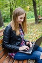 Happy young girl with laptop outdoors Royalty Free Stock Photo