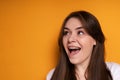 Happy young girl laughs with her mouth wide open rejoicing in the installation of braces and looks to the side Royalty Free Stock Photo