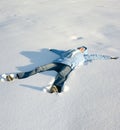 Happy young girl lying in the snow Royalty Free Stock Photo