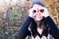 Happy young girl outdoors showing a binocular Royalty Free Stock Photo