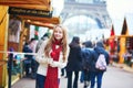 Happy young girl on a Parisian Christmas market Royalty Free Stock Photo