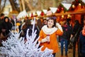 Happy young girl on a Parisian Christmas market Royalty Free Stock Photo