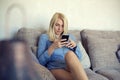 Happy young girl relaxing on the sofa enjoying Royalty Free Stock Photo