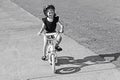 Happy young girl riding a bike in the park Royalty Free Stock Photo