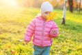 Happy young girl smiling in beautiful autumn park on nature walks outdoors. Little child playing with falling yellow maple leaf in Royalty Free Stock Photo