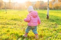 Happy young girl smiling in beautiful autumn park on nature walks outdoors. Little child playing with falling yellow Royalty Free Stock Photo