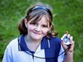 Happy young girl with stop watch at sports day