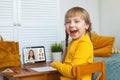 Happy young girl student studing at home. Online video call with teacher, online learning. Happy child Royalty Free Stock Photo