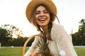 Happy young girl in summer hat having a picnic at the park, Royalty Free Stock Photo